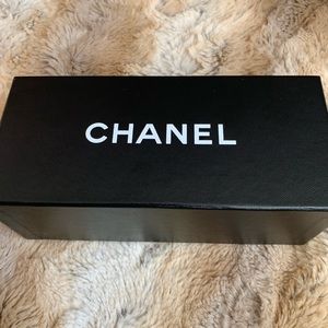 Chanel black sunglasses with CC on each side.